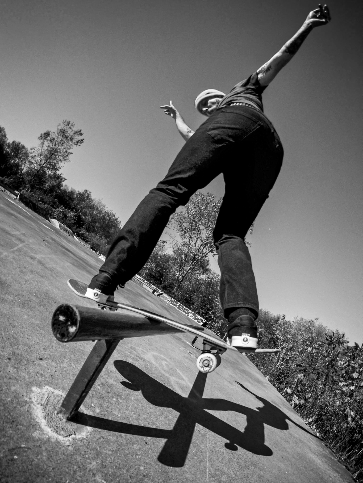 Joe Pelow performing a Backside Lip Slide at a DIY skatepark